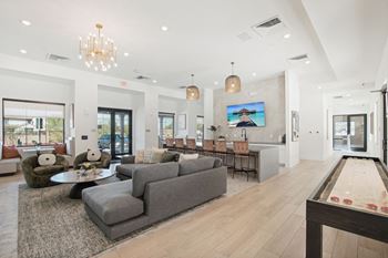a living room with couches and chairs and a dining room table at The Maddox Luxury Apartment Homes, Buckeye, AZ, 85326